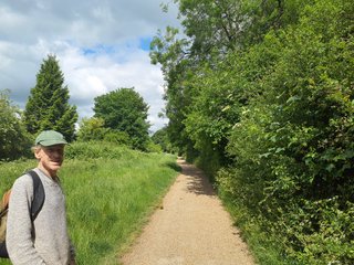 Robert on the path out of Dunstable.  Trees on the right hand side and grass on the left